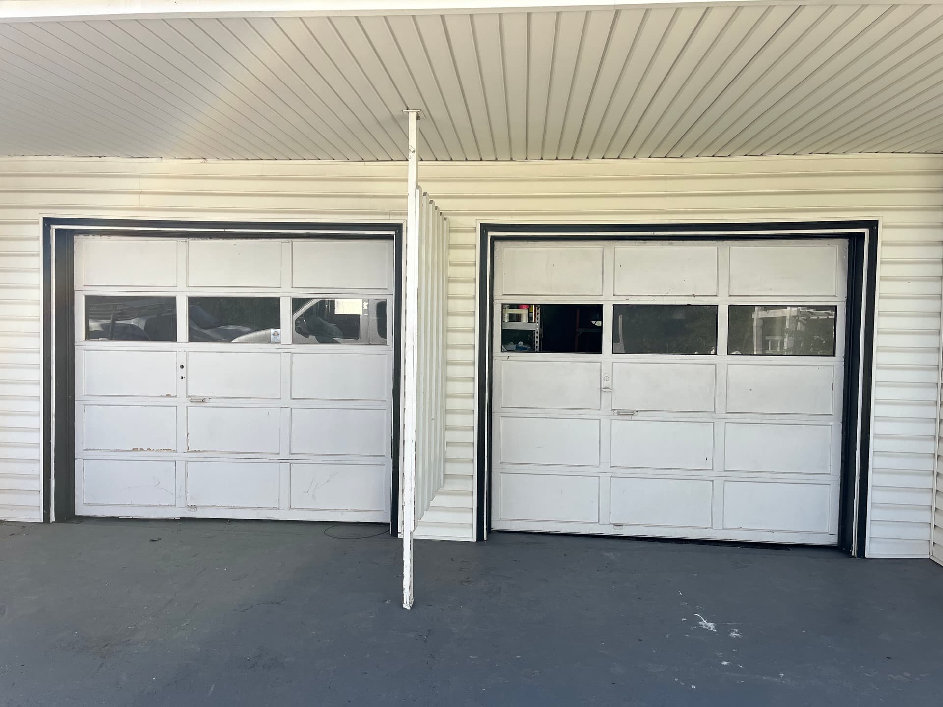 Old Wooden Garage Doors Replaced With Black Steel Insulated Doors image