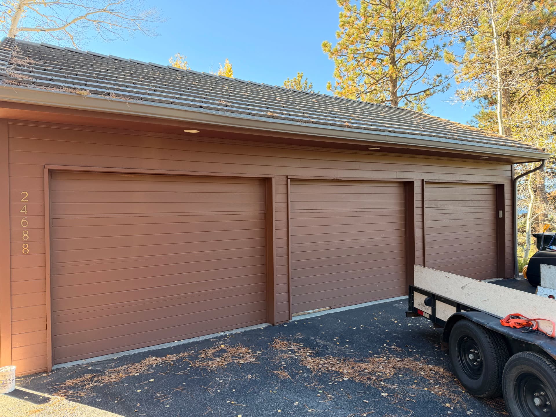 Old Wood Doors Out, Sleek Black Garage Doors In image