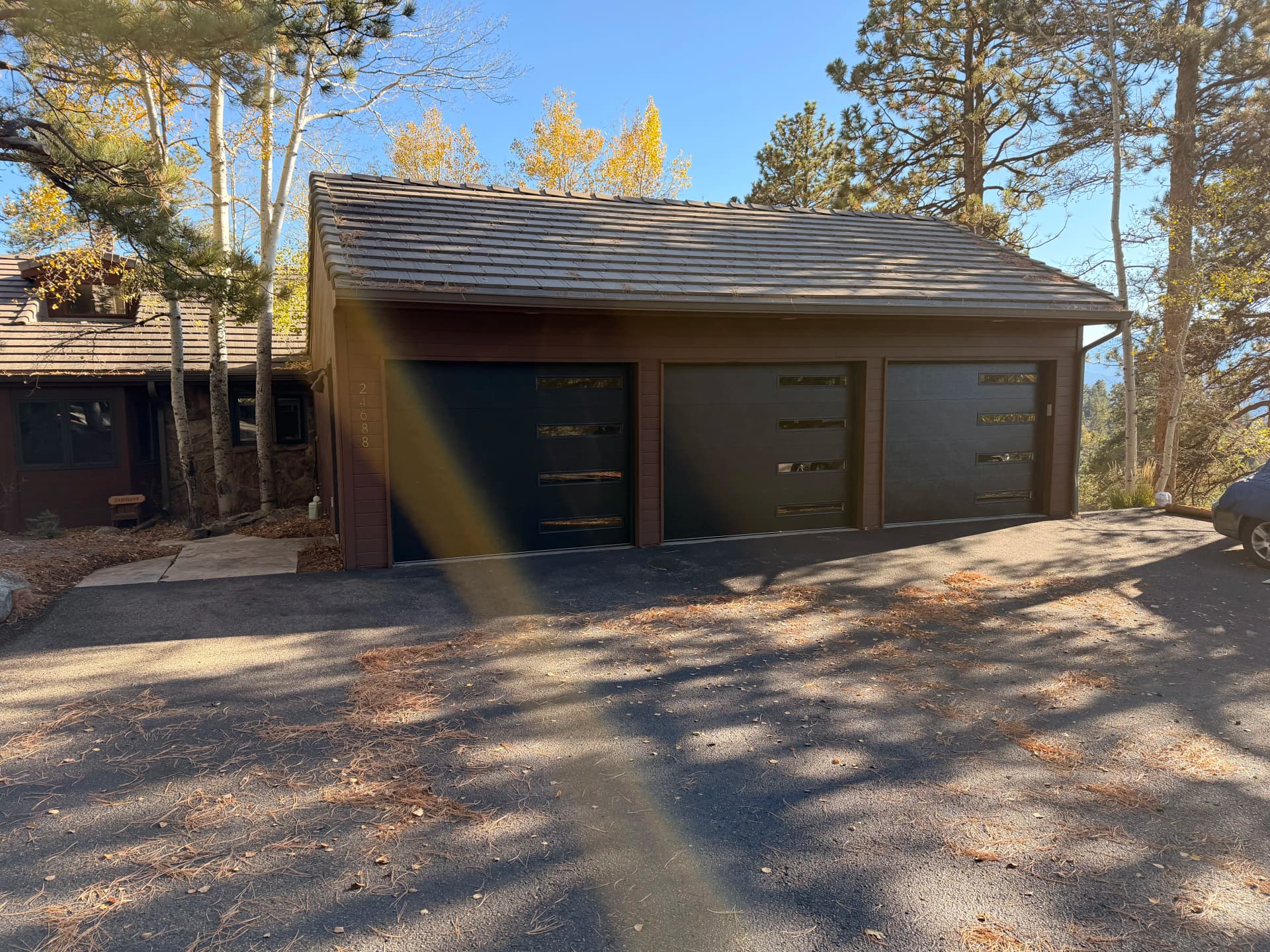 Gallery photos for Old Wood Doors Out, Sleek Black Garage Doors In: Image #1